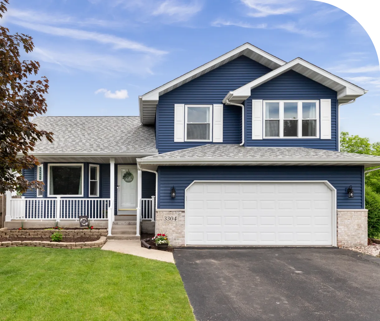 Blue suburban house with white garage door.