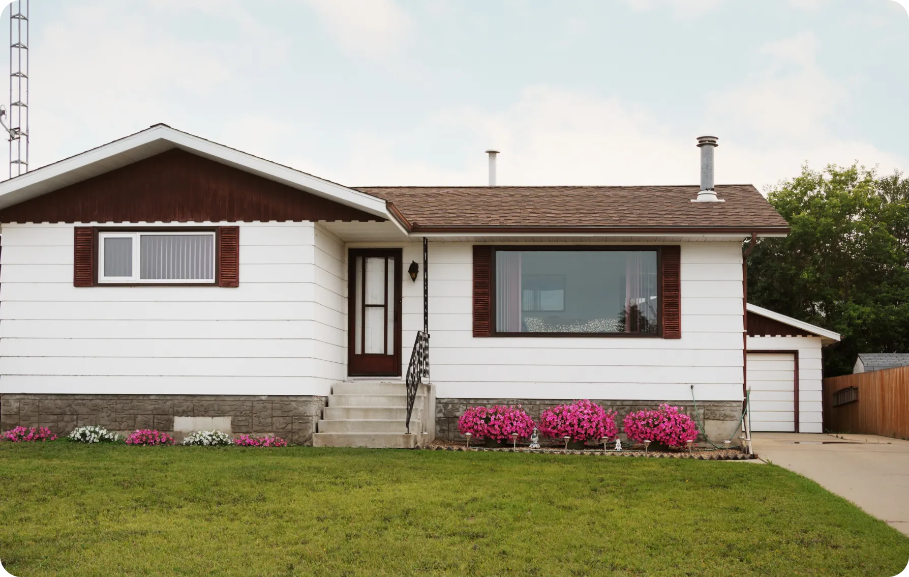 Single-story house with flowers in front.